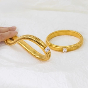 Detailed macro view showing the flexible striped texture and zircon of the gold cuff bracelet