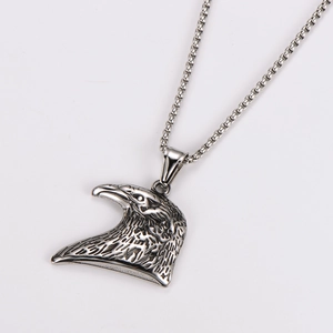 Macro detail of retro eagle head pendant on a silver stainless steel chain necklace