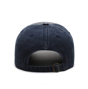 Detail of adjustable metal buckle on dark blue washed denim baseball cap with vintage finish