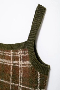 Close-up of vintage plaid knitted vest showing brown and green wool blend texture