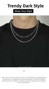 Close-up of double layer silver titanium steel chain necklace on a black T-shirt