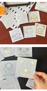 Close-up of cute cartoon laser stickers with metallic shine for water bottles and journals