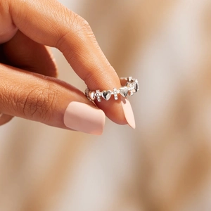 Close-up of S925 silver ring featuring alternating heart and cross patterns with zircon