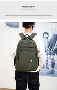 Detailed back view of an army green canvas business backpack worn by a model