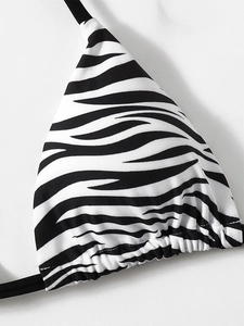 Detail of zebra print bikini top with ruched hem and adjustable black string ties