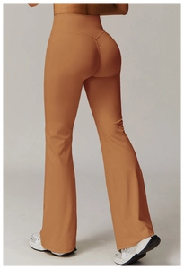 Detail view of high-waisted yoga flare pants in caramel brown with butt-lifting seam design
