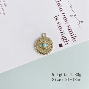 Detail of gold evil eye pendant with green stone, 21x18mm size and 1.83g weight