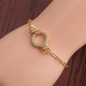 Close-up of gold HipHop bracelet with zircon circles on a paperclip chain