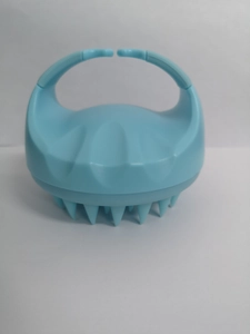 Detailed view of light blue silicone scalp massager brush with soft cone-shaped bristles
