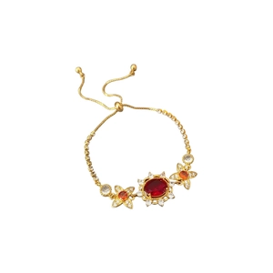 Vintage gold bolo bracelet with oval red gemstone and clear zircon floral design