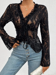 Detail of black lace long sleeve V-neck top with ruffle trim and slim fit design