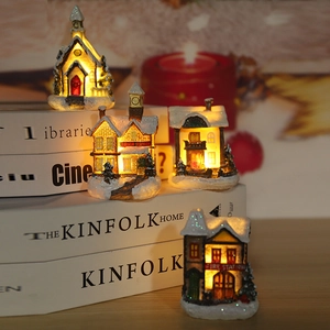 Set of 4 lighted Christmas village houses on books with warm LED glowing effect
