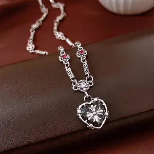 Gothic heart cross pendant necklace with red zircon in vintage silver finish on jewelry box
