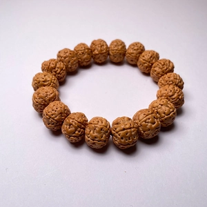 Macro detail of natural Rudraksha beads with intricate textures and warm brown tones