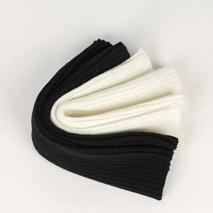 Detail of ribbed knit texture on black and white leg warmers for autumn and winter