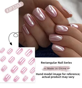 Macro detail of short square press-on nails in iridescent light pink with pearl finish