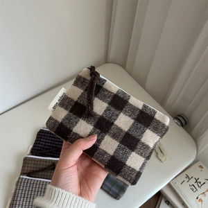 Mini wool plaid coin purse with zipper and simple wish label held in hand