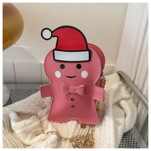 Close-up of pink gingerbread man bag with red Christmas hat and gold chain strap