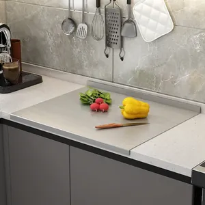 Stainless steel cutting board with L-shaped edge on a kitchen counter for meal prep
