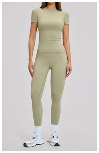 Close-up of high-waist yoga set with pale olive green slimming leggings and crew neck tee