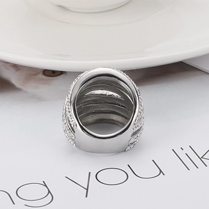 Chic multi-layer silver ring with sparkling crystal pavé on a minimalist desk setting