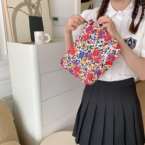 Floral cotton makeup bag detail showing zipper closure and high-quality printed fabric