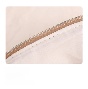 Detail showing high-quality stitching and zipper craft on a cream teddy velvet bag