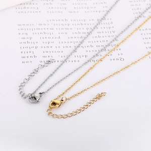 Detail of gold and silver stainless steel necklaces showing lobster clasp and extender