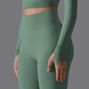 Detail of sage green seamless knit yoga set featuring thumbholes and wide ribbed waistband