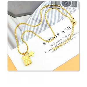 Detailed macro view of gold-plated star checkerboard square pendant in titanium steel