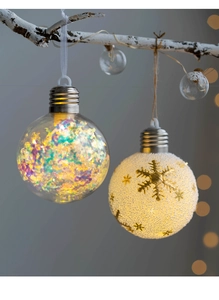 Detail of Christmas snowflake ball ornaments with iridescent and snowy gold glitter patterns