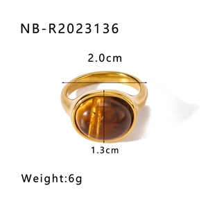 Macro shot of gold stainless steel ring with 1.3cm oval tiger eye stone and size labels