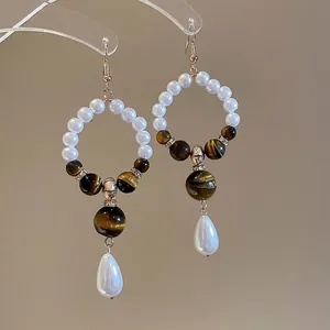 Retro tiger eye and pearl drop earrings with elegant silver pin and gold accents