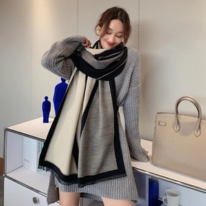 Close-up of thick bicolor cashmere feel scarf with decorative wavy edge stitching details