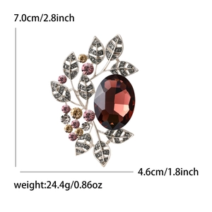 Elegant crystal leaf brooch with large reddish-brown gemstone and pink rhinestones