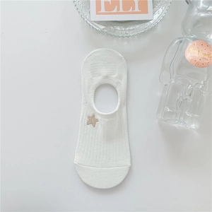 Close-up of white cotton invisible sock with gold star embroidery and ribbed cuff details