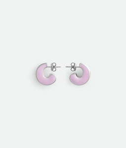 Macro detail of C-shaped earring featuring matte pink enamel on a polished silver base