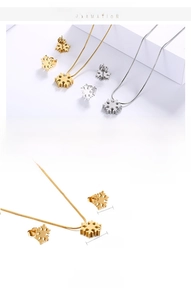 Macro detail of snowflake necklace and stud earrings set with dimension measurements