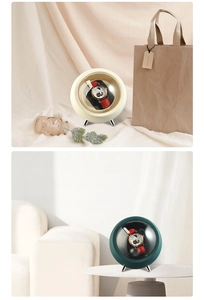 Spherical automatic watch winder in beige and green featuring a clear acrylic window