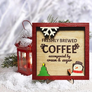 Detail of wooden Christmas coffee sign with snowman and tree on a festive winter background