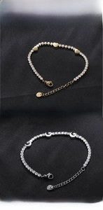 Detail of titanium steel bracelets with heart, star and moon charms and cubic zirconia