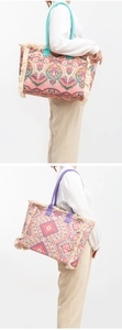 Close-up of bohemian woven tote bags with colorful paisley patterns and stylish tassels
