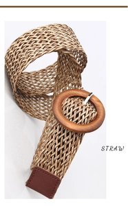 Detail of bohemian straw woven belt with round wooden buckle and dark brown leather tip