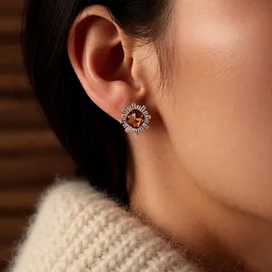 Vintage 18k gold plated sunburst stud earring with amber zircon on model's ear