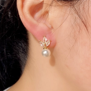 Elegant marquise zircon and pearl drop earrings shown on model ear with sparkling light