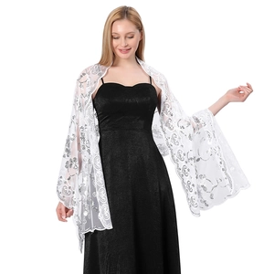Elegant white lace shawl with silver sequin embroidery over a black evening dress
