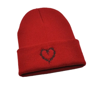 Winter red knitted beanie with black heart embroidery for casual warmth and style