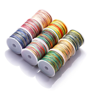 Detailed view of seven assorted multi-color gradient nylon cords for DIY jewelry weaving