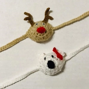Detail of handmade crochet reindeer and bear nose warmers with soft knit texture