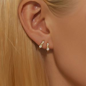 Close-up model view of 925 silver gold hoop earrings with white opal and small diamonds